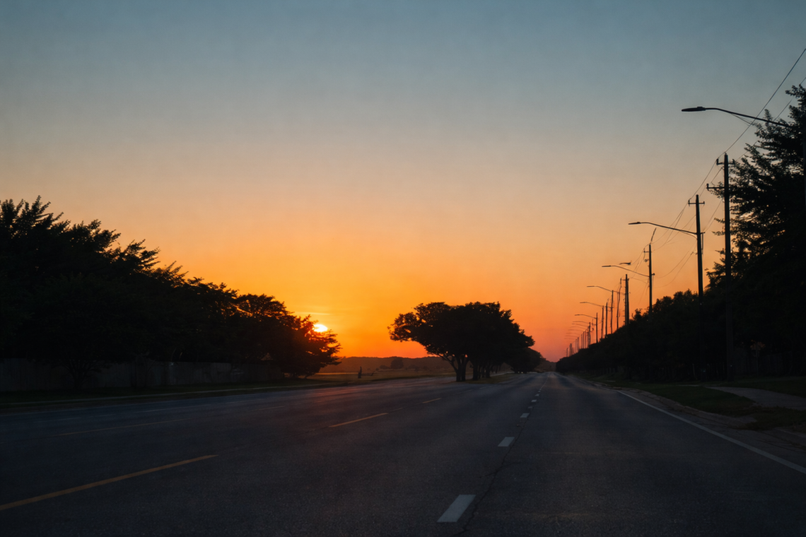 Empty road at sunset with soft light on the horizon