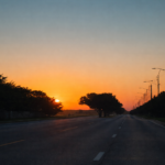Empty road at sunset with soft light on the horizon